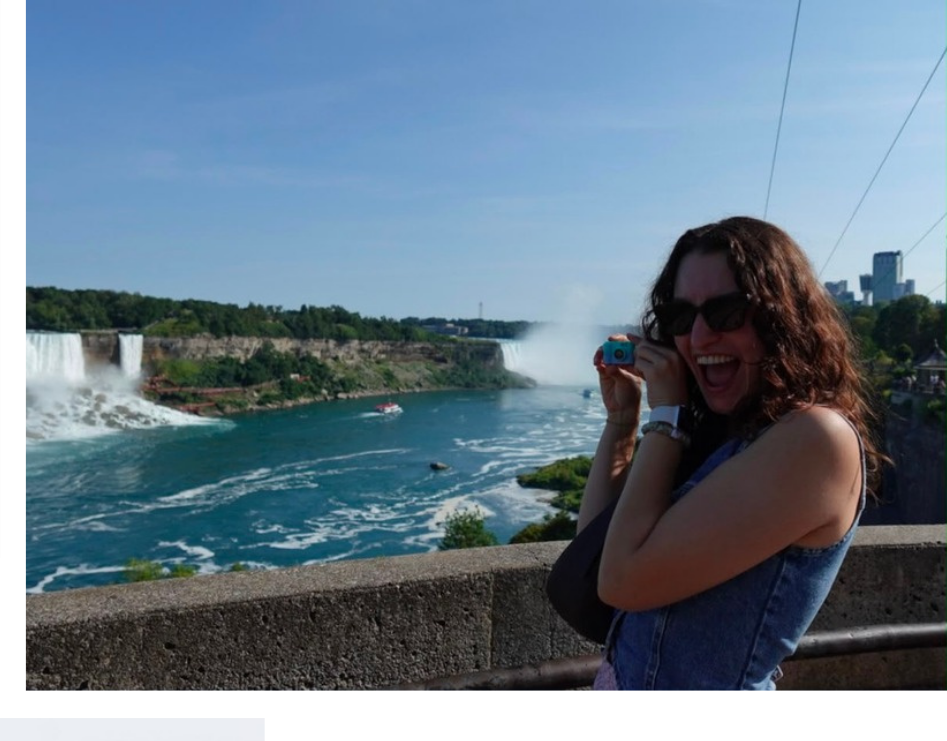 Carolina laughing at Niagara Falls with a tiny blue camera
